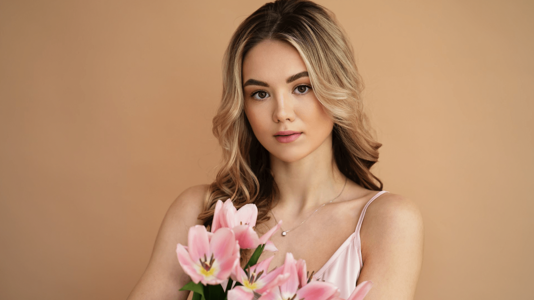 woman in pink top holding bouq
